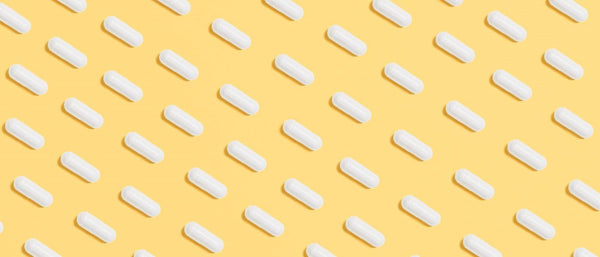 white pills on a yellow background