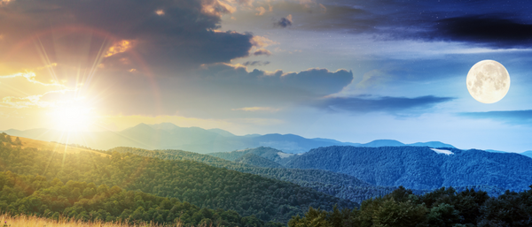 stunning landscape depicting both day and night in one scene—one side illuminated by a bright sun with golden hues